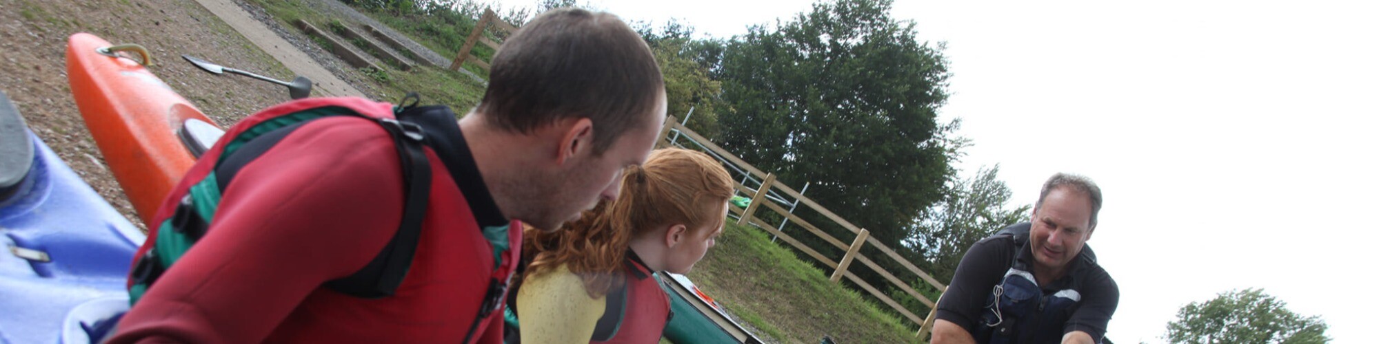 Two adults being instructed in water sports