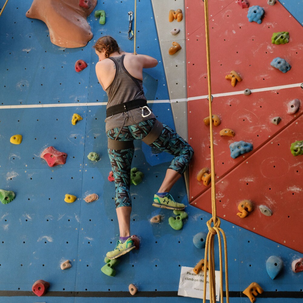 Woman climbing at Aztec Adventure Evesham