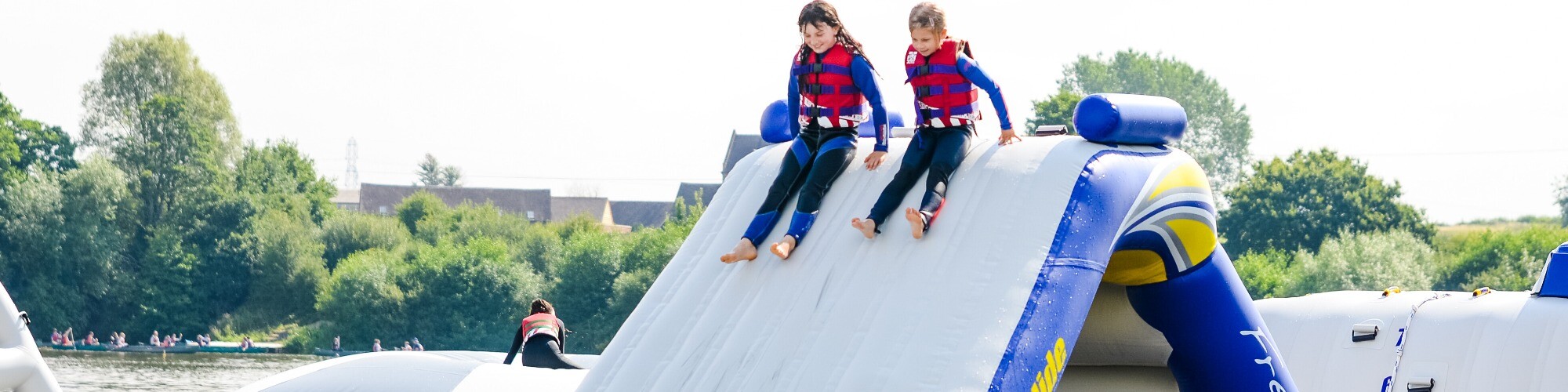 Two Children at the top of an inflatable slide at the Aztec Adventure Aqua Park