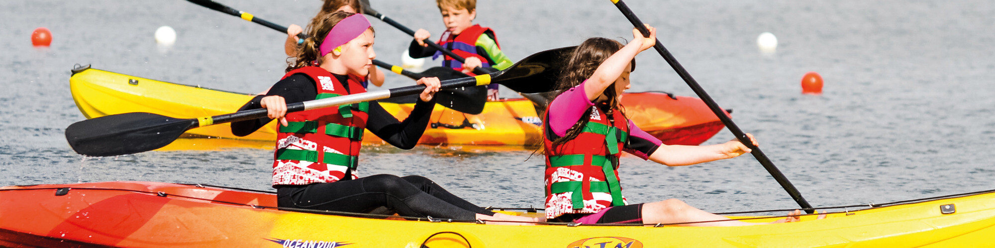 Two girls in a double sit on top kayak