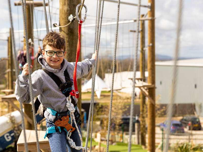 Child on aerial adventure course at The Lost Valley, The Valley Evesham