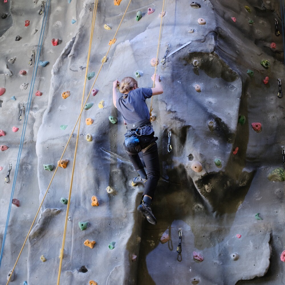 Woman climbing at Aztec Adventure Evesham